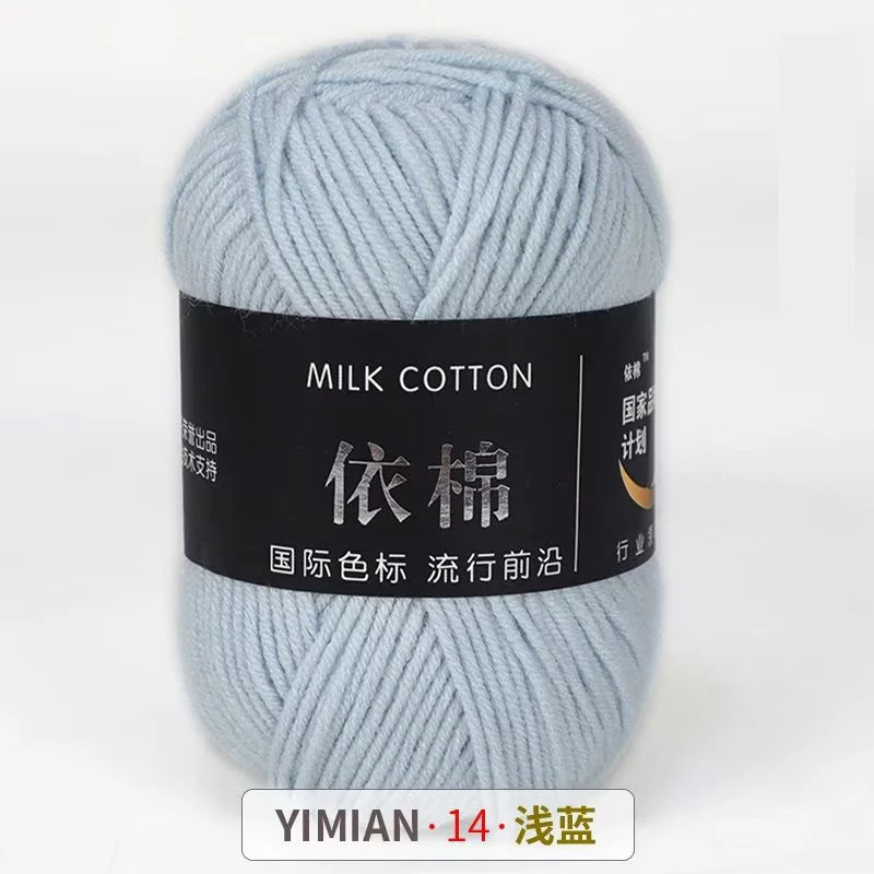 A ball of light blue milk cotton yarn labeled with Chinese characters and a size indicator.