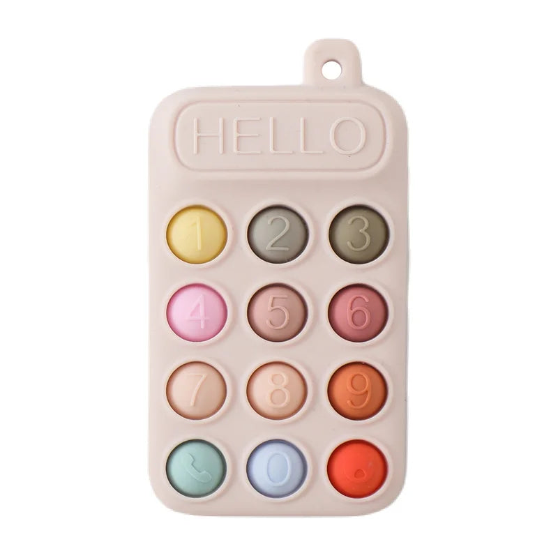 A pink silicone baby teether toy with numbered and lettered buttons for teething