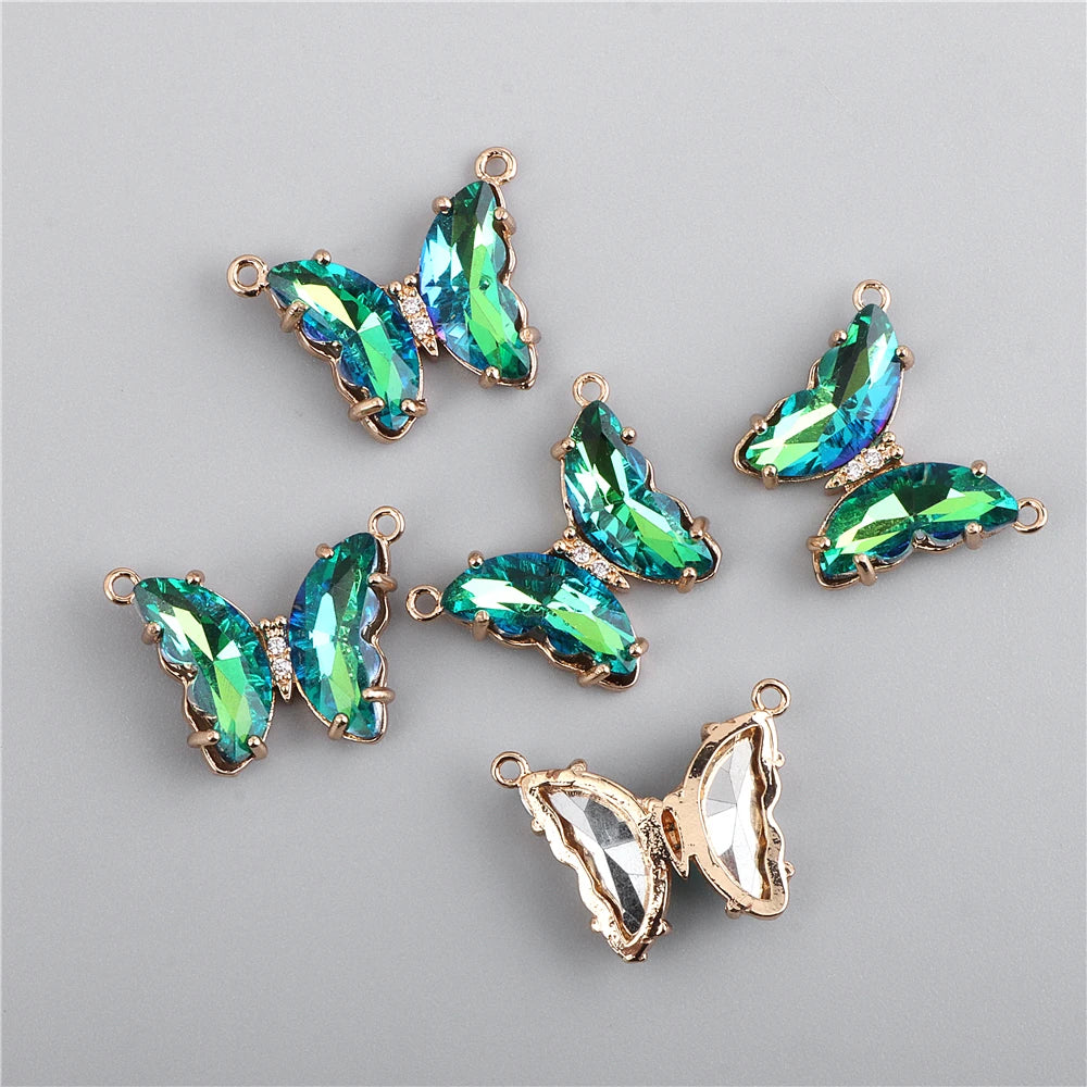 A set of crystal butterfly charm beads in green and blue tones for jewelry making.