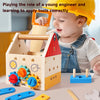 A baby is playing with a wooden toolbox toy featuring gears and tools for learning to apply them correctly.