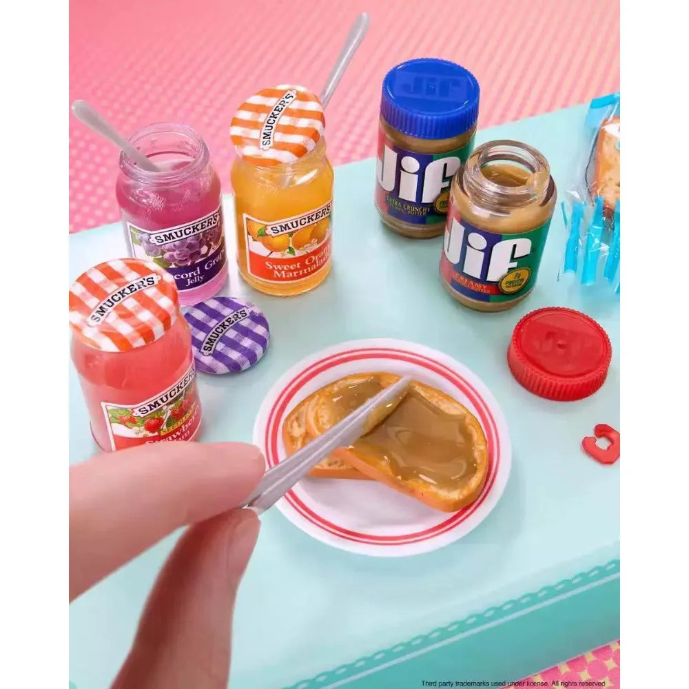 A collection of small glass jars and a toy vending machine with snack dispensers and surprise balls
