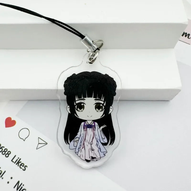 A clear acrylic pendant featuring an anime-style girl with black hair and a purple bow, attached to a black cord.