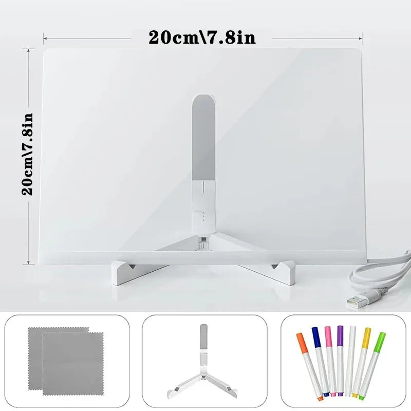 A white glowing LED message board with a silver stand and a set of colored pens and an eraser.