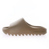 A tan EVA platform slide with a textured sole shown from the side.
