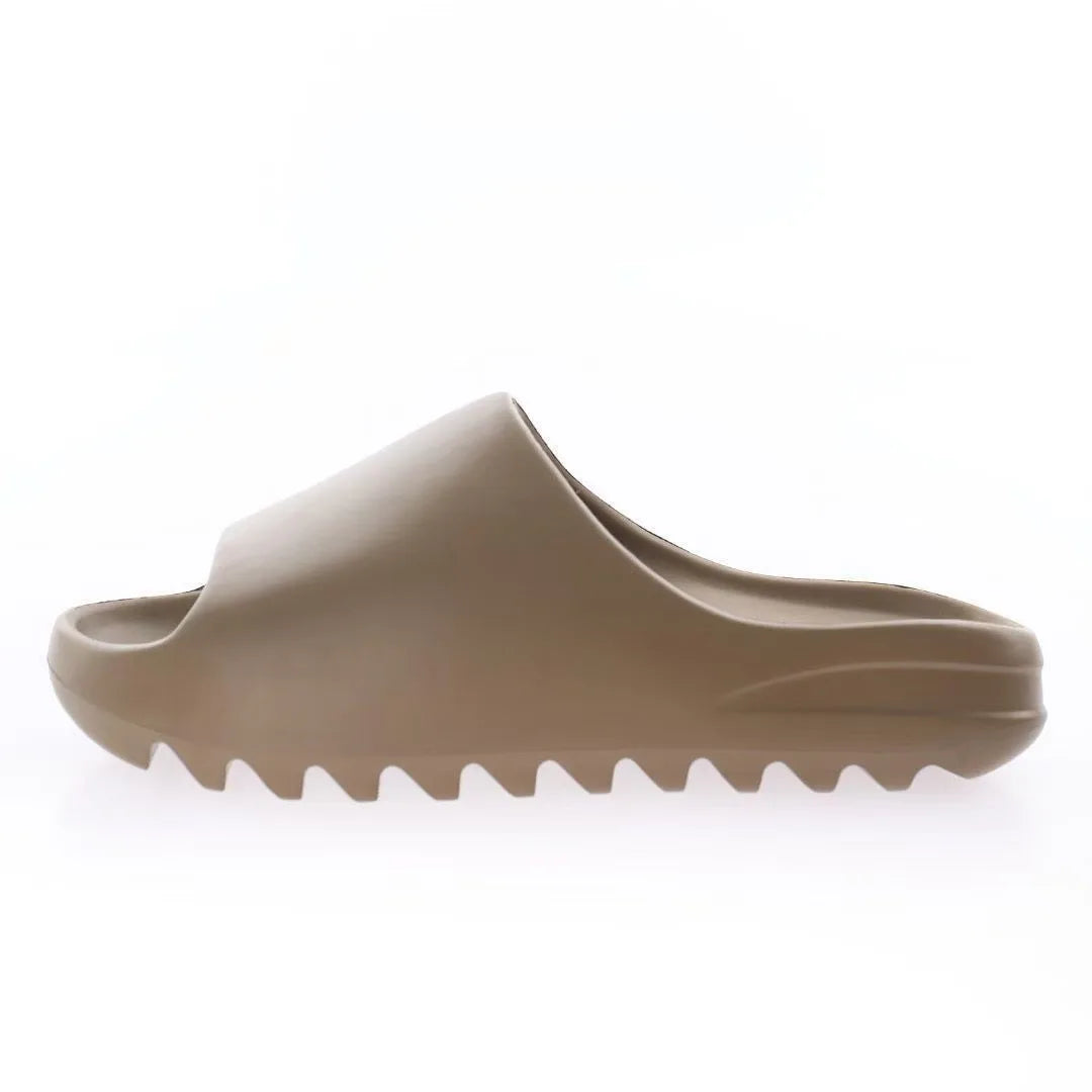 A tan EVA platform slide with a textured sole shown from the side.