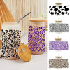 A set of leopard print UV DTF cup wraps featuring black and purple patterns on clear glass cups.