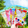 A collection of colorful DIY cartoon coloring painting kits for kids displayed outdoors.