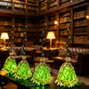 Animated witch broom with a green LED glow displayed on a dark wooden table.