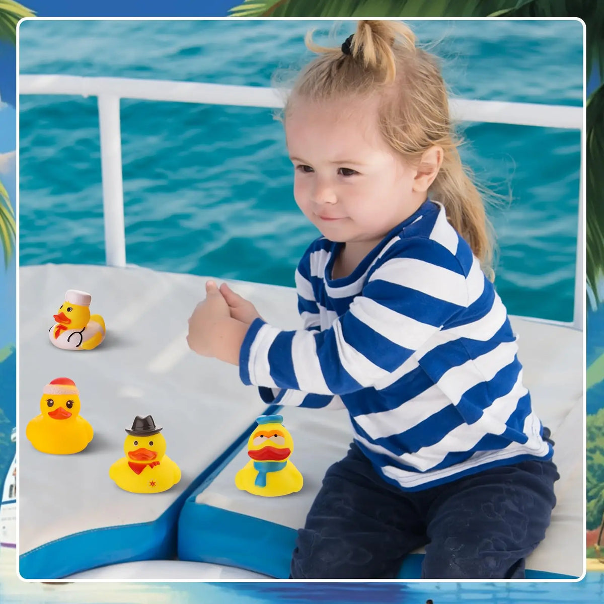 A young girl is playing with assorted yellow and orange rubber ducks on a blue surface near the water.