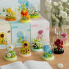 A collection of clear glass flower building blocks in various colors and arrangements displayed on a wooden surface.