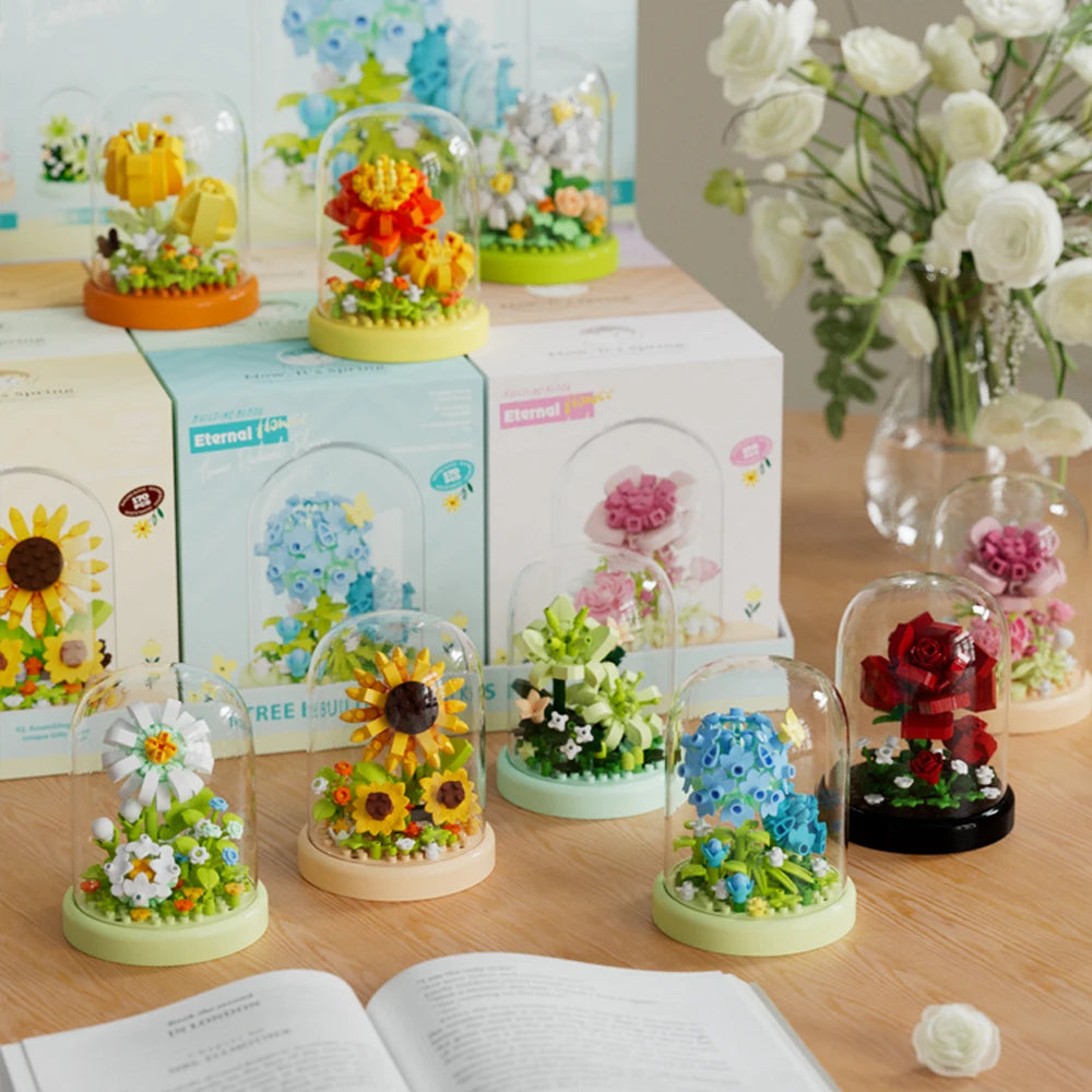 A collection of clear glass flower building blocks in various colors and arrangements displayed on a wooden surface.