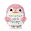 Handmade crochet pink penguin doll holding a card with the message I may be a tiny penguin but I believe in you Go do your th