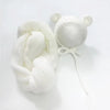 A white knit bear hat and wrap set with small ears and a pom-pom detail.