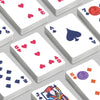 A close-up view of a classic joker poker playing card deck featuring various colored cards and symbols.