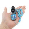 A hand holds an adjustable tone kazoo with a lanyard in vibrant blue and black colors.