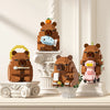 A set of cute capybara micro building blocks in brown and pink colors displayed on a light-colored cabinet.