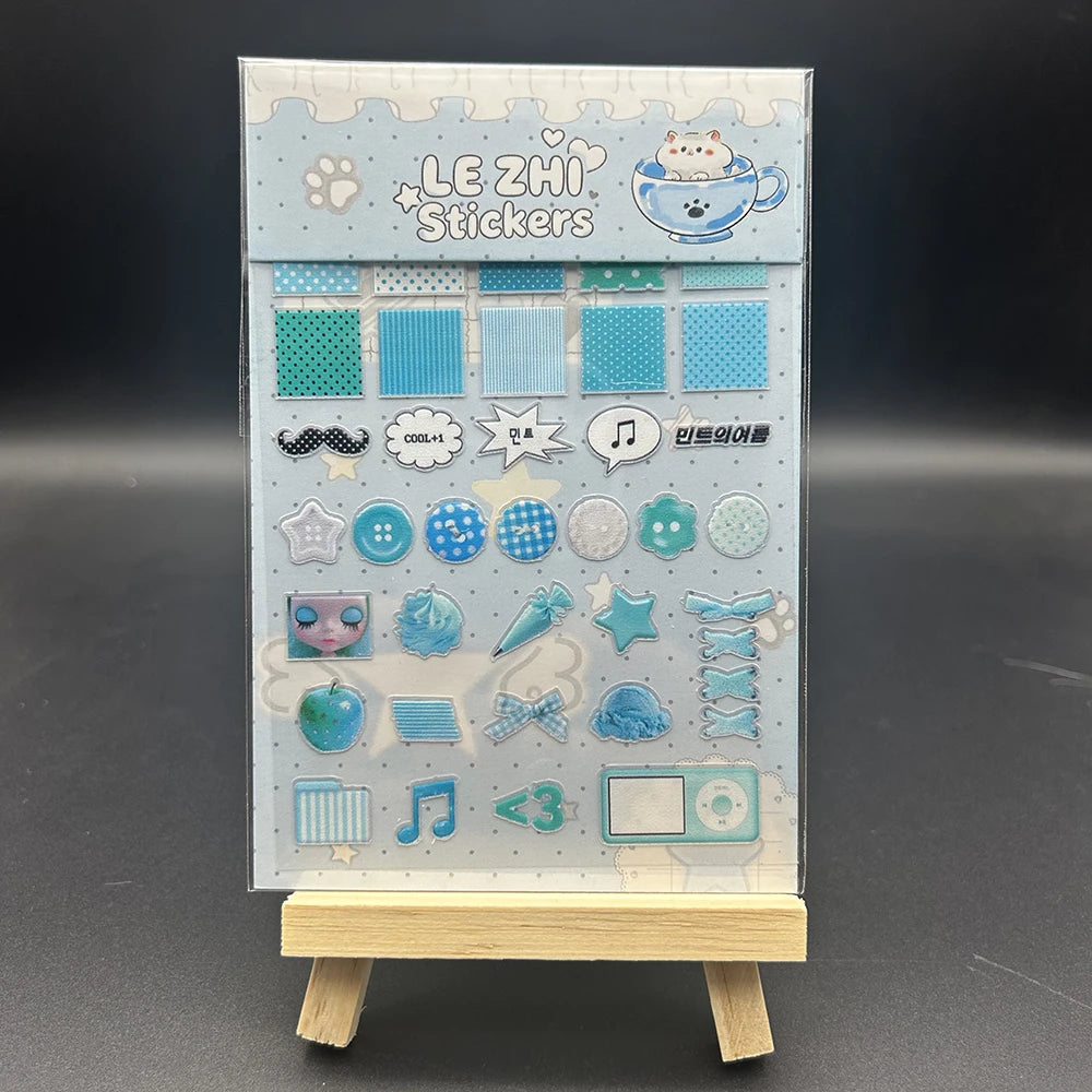 A vertical display of various cute decorative stickers on clear sheets with a light blue background.