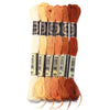 A set of six skeins of vibrant embroidery thread in various shades of orange and cream for cross stitch and DIY crafts