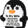 Black and white penguin plush toy with a sign that reads To My Wife You're My Penguin