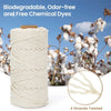 Roll of natural off-white cotton macrame rope with four twisted strands against a background of dried white flowers