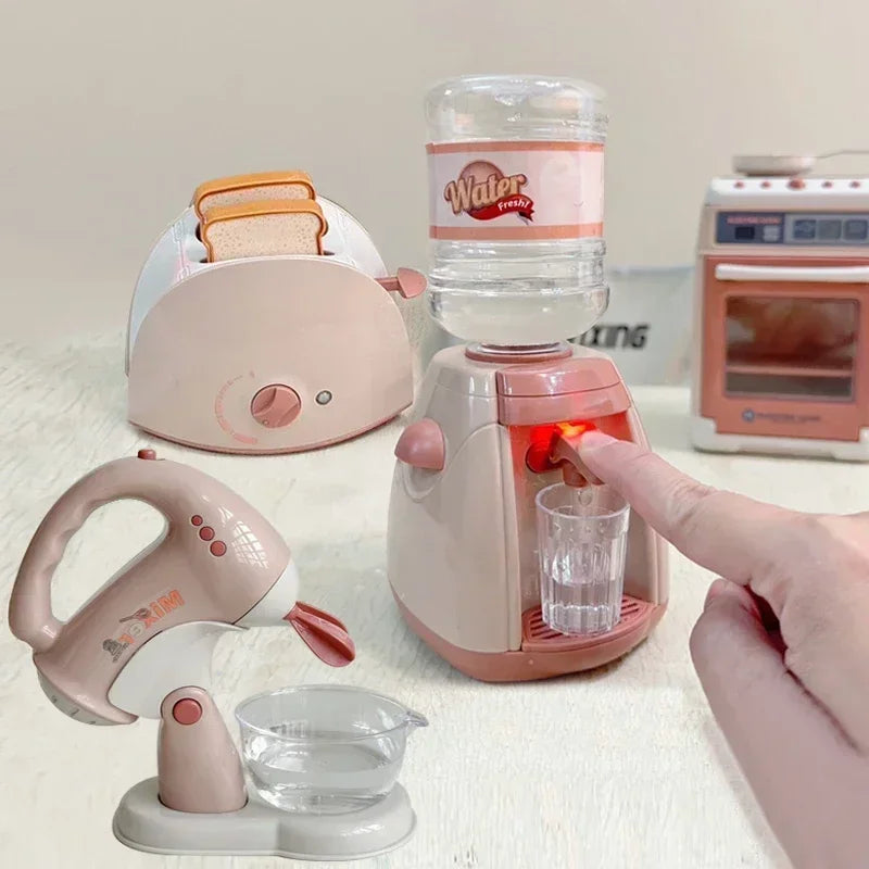 A pink kids pretend play kitchen set featuring a coffee maker, water dispenser, and toaster on a white surface.