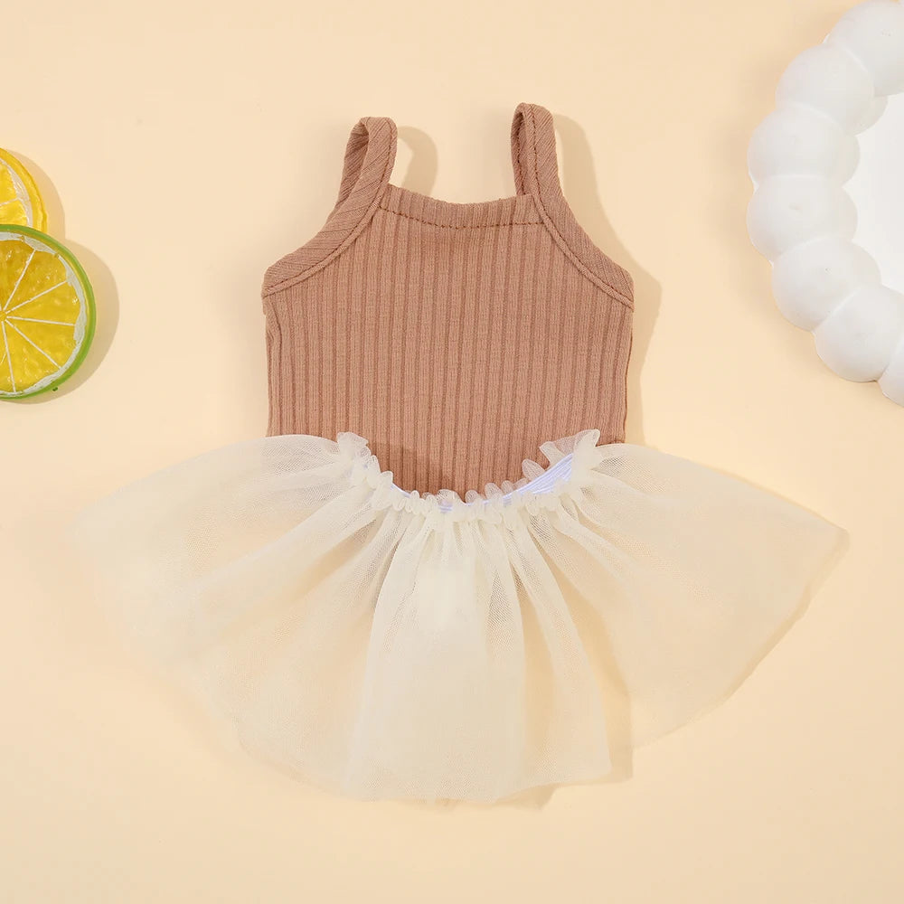 A beige ribbed top and sheer tulle skirt set for a baby doll outfit.