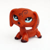 An orange dachshund bobblehead figurine with large blue eyes and decorative swirls.