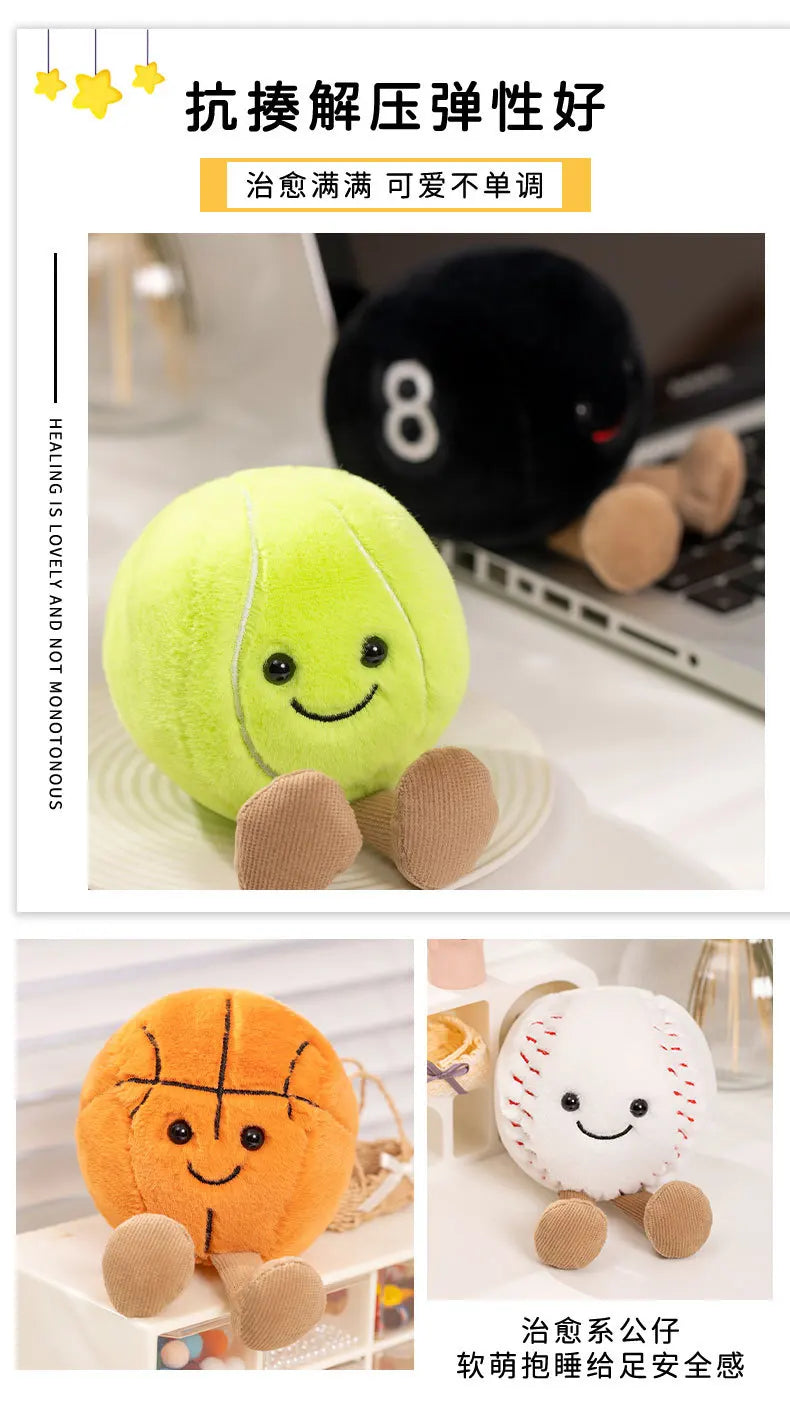A yellow plush doll shaped like a sports ball with stitched features and brown hands, displayed next to an orange plush ball.
