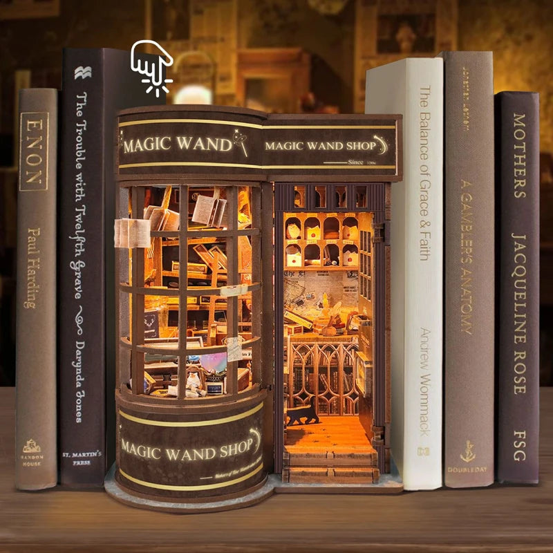 A wooden miniature kit of a magic wand shop display featuring various items and books.