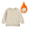A beige kids pullover hoodie with a hood and ribbing is shown next to a burst of orange flame.