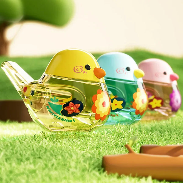 A collection of colorful, smooth, egg-shaped musical toys for infants and children sitting on green grass.