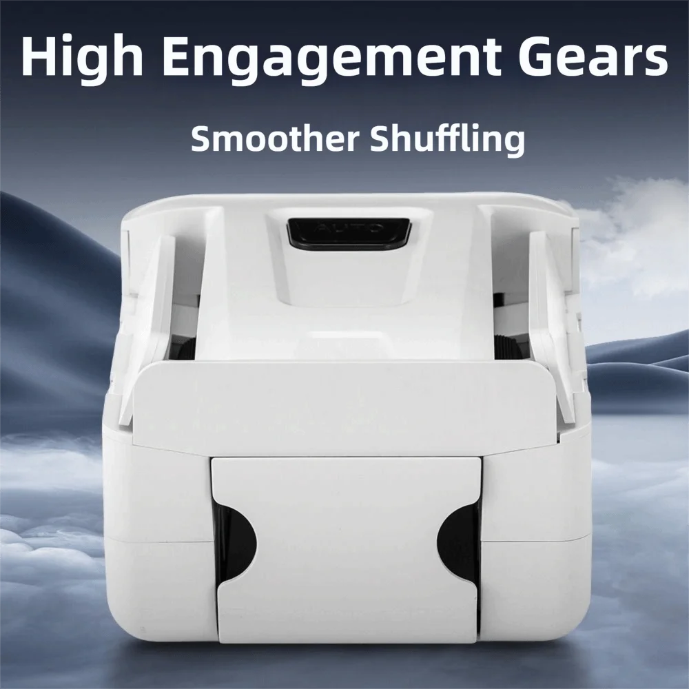 A white portable automatic card shuffler device is shown against a cloudy, mountainous background.