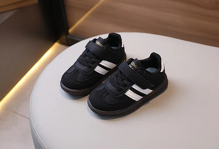 A pair of black and white casual sneakers resting on a white surface.