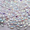Clear water drop Czech glass beads scattered on a white surface for jewelry making