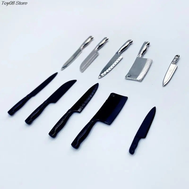 A collection of miniature metal kitchen knives for a dollhouse, including various blade shapes and sizes.