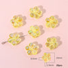 A collection of yellow translucent acrylic flower beads for DIY jewelry making, showing various sizes and a measurement scale