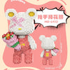 A pink brick art bear figure holding a bouquet of colorful flowers, displayed against a light background.