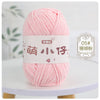 A ball of pink chenille yarn labeled with Chinese characters for knitting and crochet.