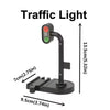 A traffic light fixture with a green, yellow, and red light, mounted on a black stand.