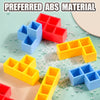 A collection of colorful ABS material stacking tower game pieces in red, blue, and yellow on a light green surface.