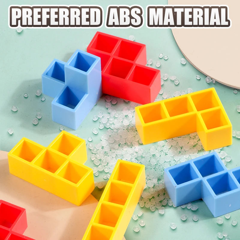A collection of colorful ABS material stacking tower game pieces in red, blue, and yellow on a light green surface.