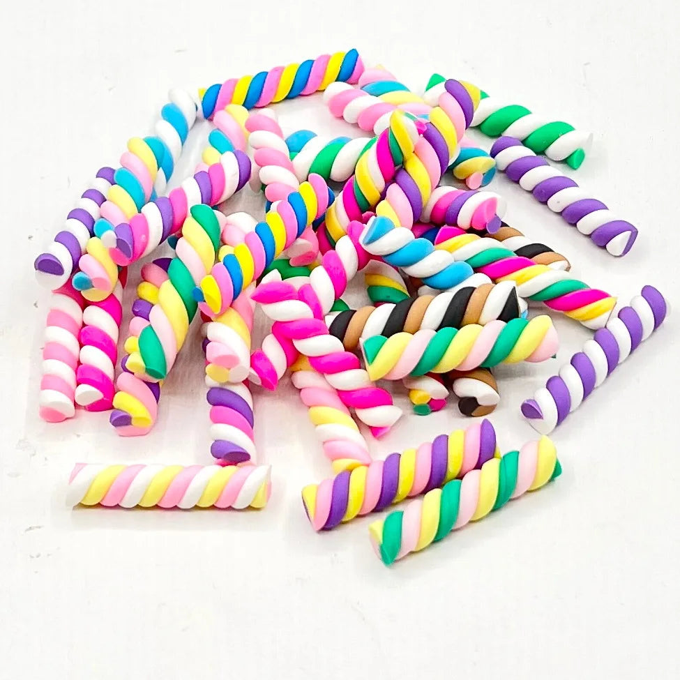 A collection of ten multicolored, striped polymer clay marshmallow charms for DIY crafts.