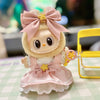 A cute doll outfit featuring pink tulle and a bow with a gold star detail.