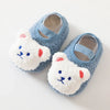 Pair of soft blue knitted bear baby booties with white fur and light blue straps
