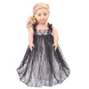 A blonde doll wearing a black lace dress and coat outfit.