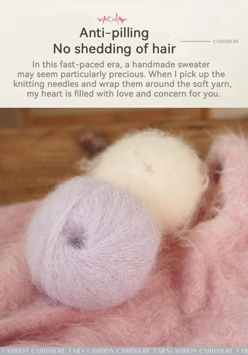 A ball of light purple yarn is shown resting on a pink knitted fabric, with knitting needles visible in the background.