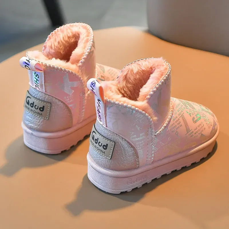 A pair of pink fur-lined winter snow boots with a white sole resting on a light surface.