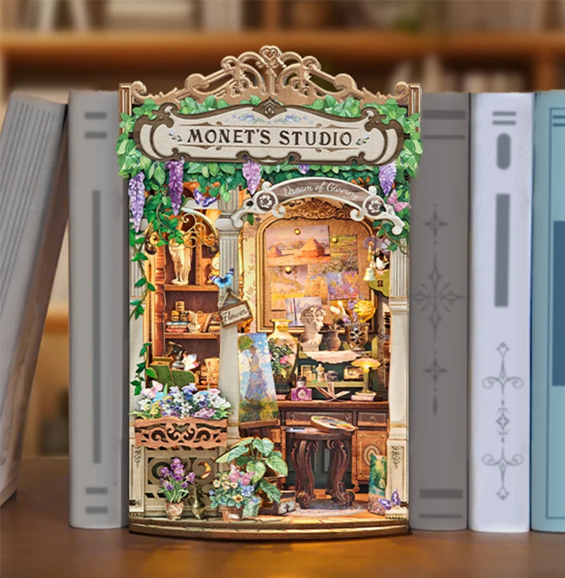 A miniature wooden book nook kit depicting Monet's studio with detailed paint and decorative elements.