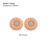 A pair of peach-colored silicone daisy sunflower beads for DIY jewelry making.