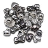 A pile of silver-toned acrylic bow and flower beads for DIY jewelry making.